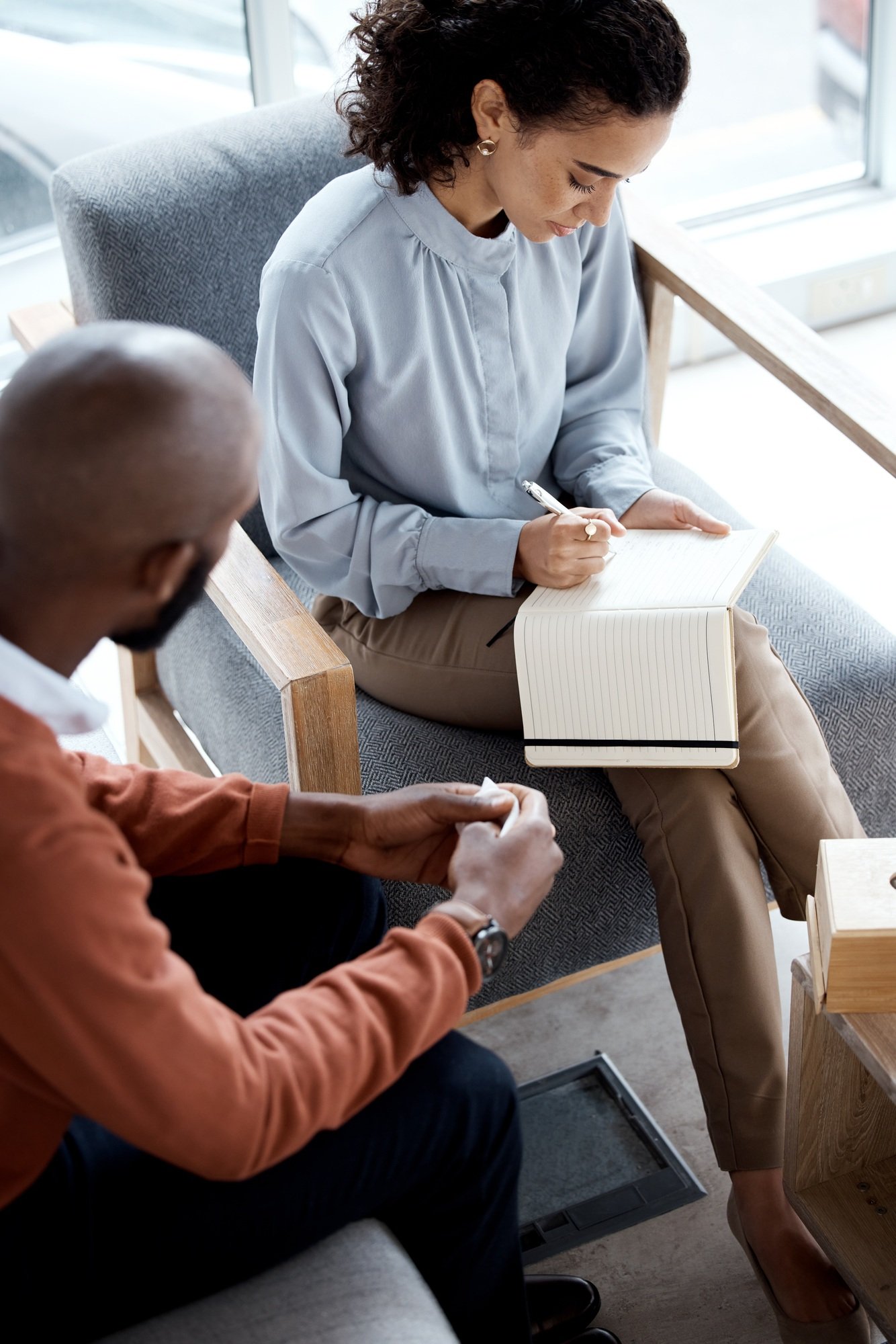 Therapy, counselling and writing notes of mental health conversation with patient and psychologist.